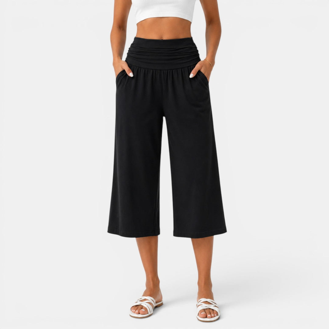 Mujer usando pantalón capri de yoga. Elástico y transpirable para fitness y entrenamiento deportivo activo.