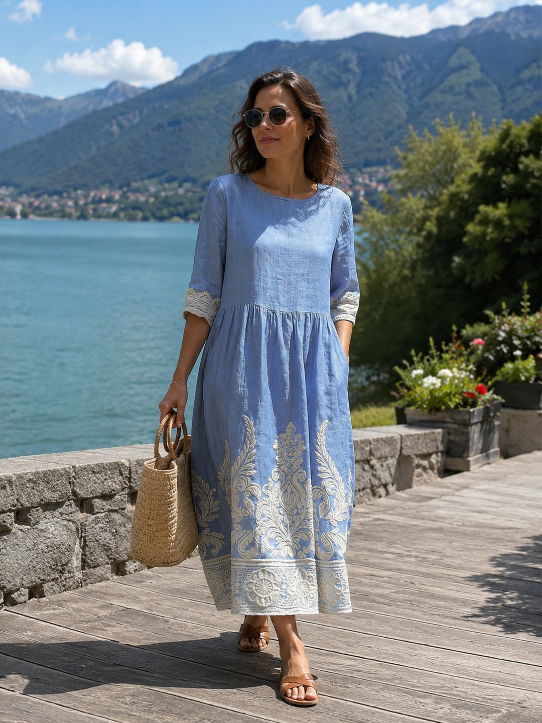 Vestido midi azul para mujer con elegantes bordados florales y mangas 3/4, ideal para estilo casual o veraniego.