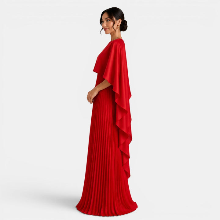 Vestido largo elegante para mujer con mangas murciélago y corte asimétrico. Resalta su estilo fluido y moderno.