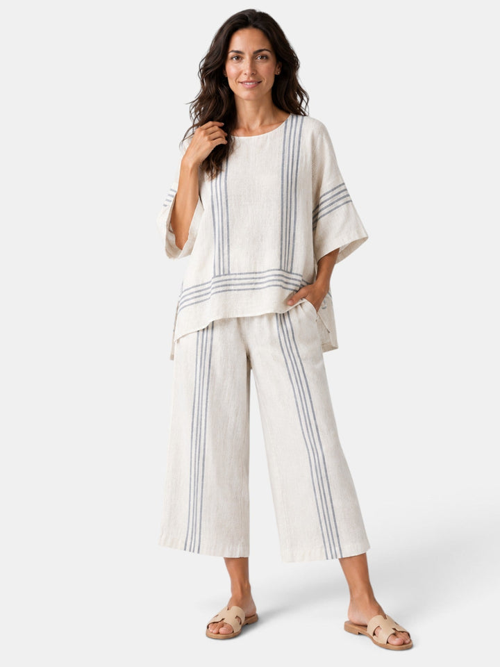 Modelo luciendo conjunto moderno de dos piezas: top asimétrico y culotte, para un look sofisticado de moda.