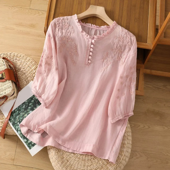 Blusa azul bordada para mujer, con detalle de cuello volante y mangas largas. Ideal para un look romántico y casual.