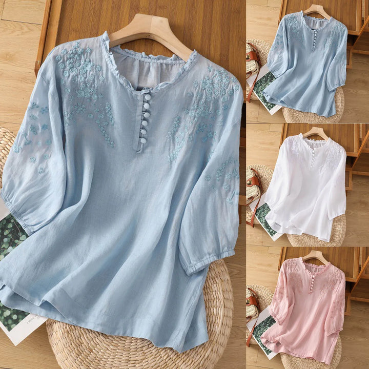 Detalle blusa blanca bordada con cuello volante y manga larga. Estilo elegante y romántico para outfits de primavera-verano.