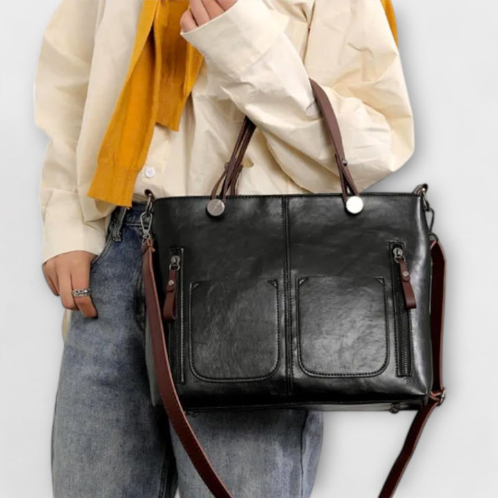 Bolso de mujer con cremallera segura y bolsillos, diseño elegante en piel sintética.