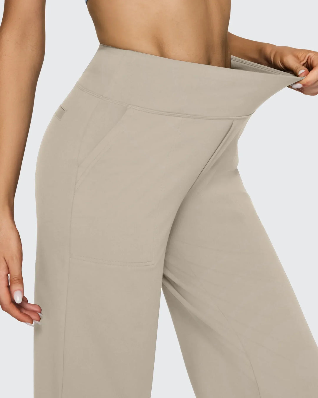 Pantalones de mujer tiro alto, pierna ancha, con bolsillos, para un estilo que celebra la feminidad moderna.