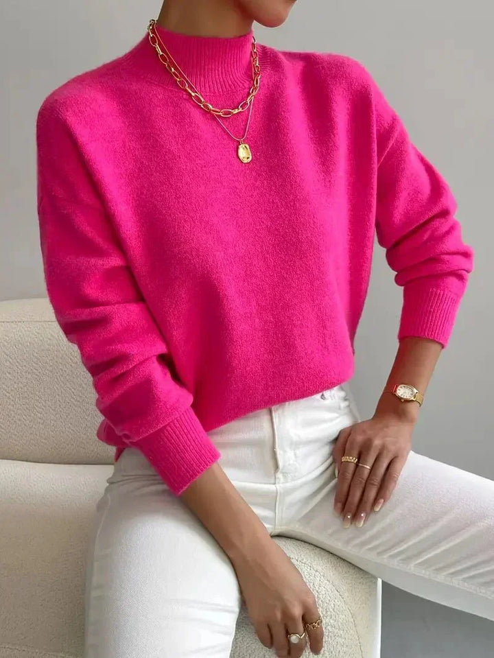 Jersey de mujer con cuello alto y manga larga en punto grueso, prenda esencial y cómoda para el frío invierno.