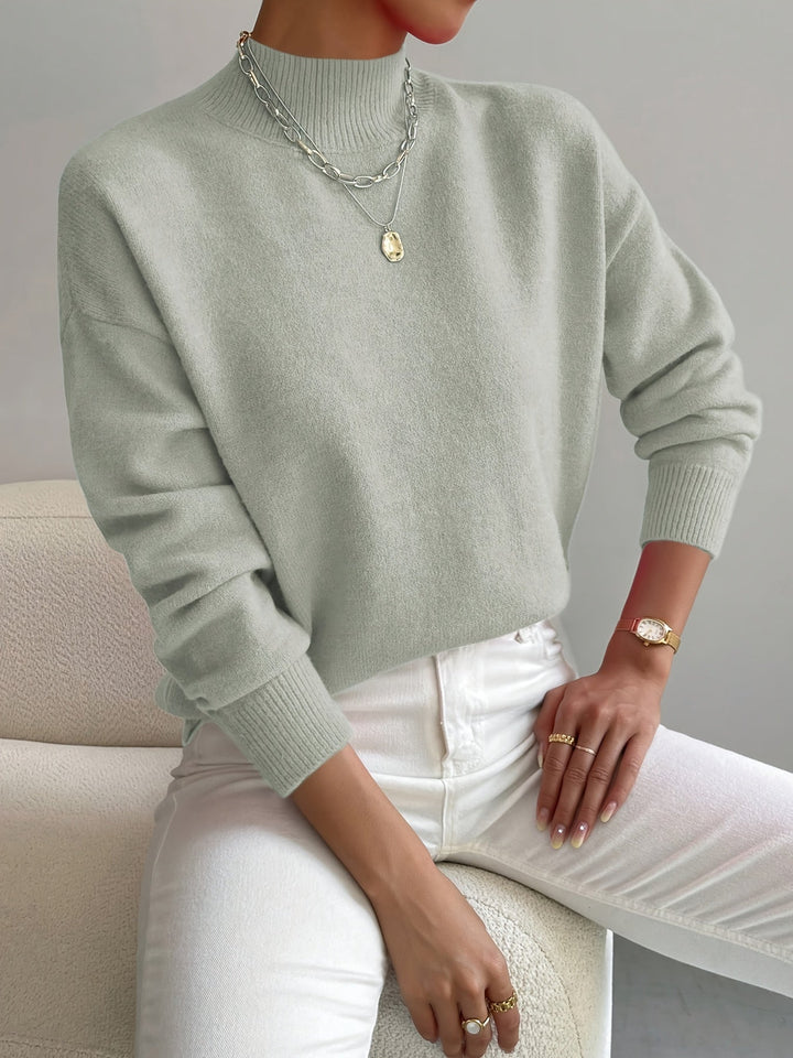 Jersey de punto grueso cuello alto para mujer, manga larga, ideal para invierno y comodidad.