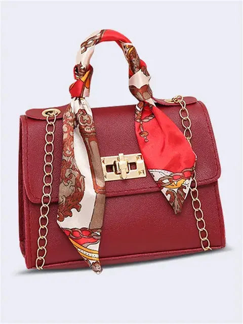 Bolso elegante de mano para mujer en material sintético de alta calidad, con cadena y pañuelo chic.