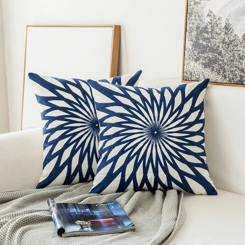 Cojín decorativo azul bordado con patrón geométrico moderno para sofá, ideal para salón y hogar.
