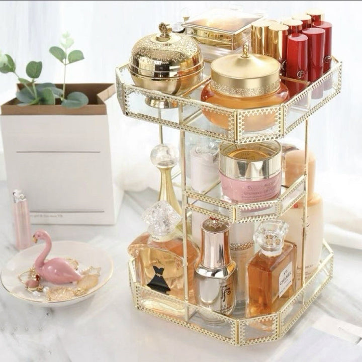 Elegante organizador giratorio de vidrio dorado para vanity, perfecto para maquillaje y perfumes de lujo.