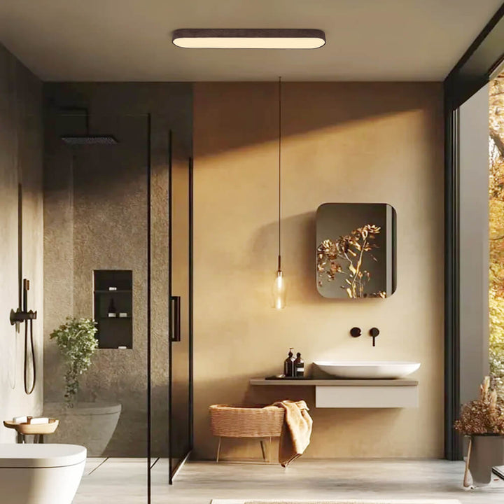 Plafón LED ovalado Japandi iluminando un salón moderno. Estilo minimalista en techo para ambientes acogedores.
