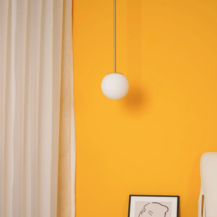 Iluminación suave con lámpara colgante de vidrio esmerilado, diseño minimalista nórdico, perfecta para comedor.