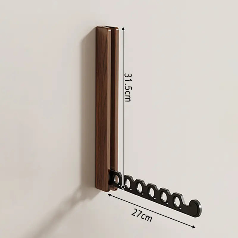 Perchero de pared plegable moderno, diseño compacto y discreto cuando no está en uso.