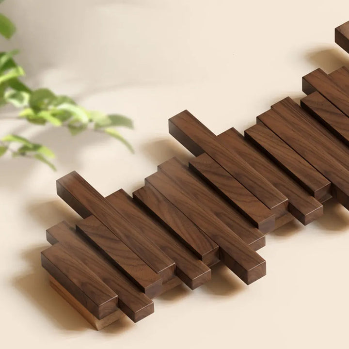 Perchero minimalista de pared con ganchos ocultos. Ideal para pasillos y espacios pequeños.