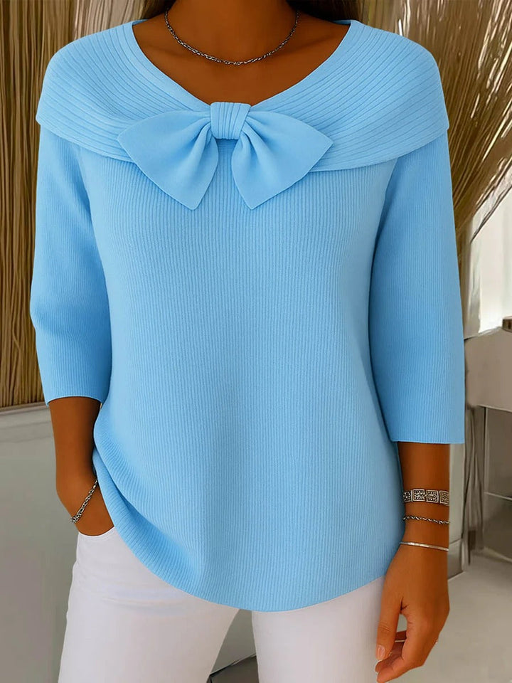 Blusa elegante de mujer con manga larga, cuello V y lazo decorativo. Perfecta para estilo casual o de oficina.