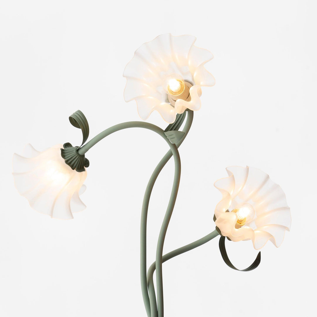 Detalle de lámpara de pie floral verde, luminaria para un toque natural en tu hogar.