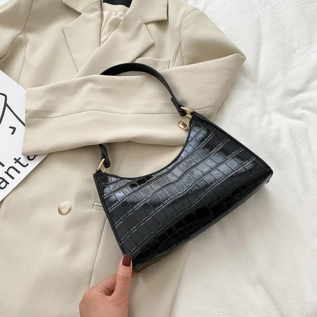 Bolso de mano de piel de cocodrilo brillante, sofisticado y moderno para mujer.