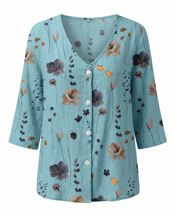 Blusa con estampado floral y detalles bordados, cuello V. Estilo femenino y corte holgado.