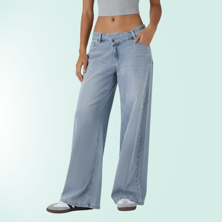 Vaqueros tiro bajo asimétricos de mujer. Elásticos, pierna ancha, azul denim casual.
