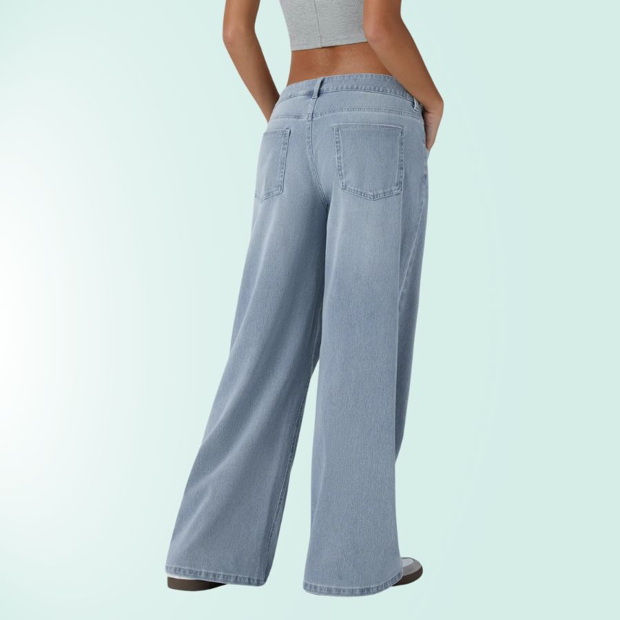 Vaqueros mujer tiro bajo, corte asimétrico, pierna ancha. Elásticos para look moderno azul.