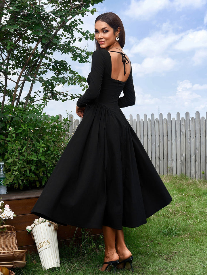 Vestido línea A con lazo en espalda, manga larga. Look favorecedor y moderno.