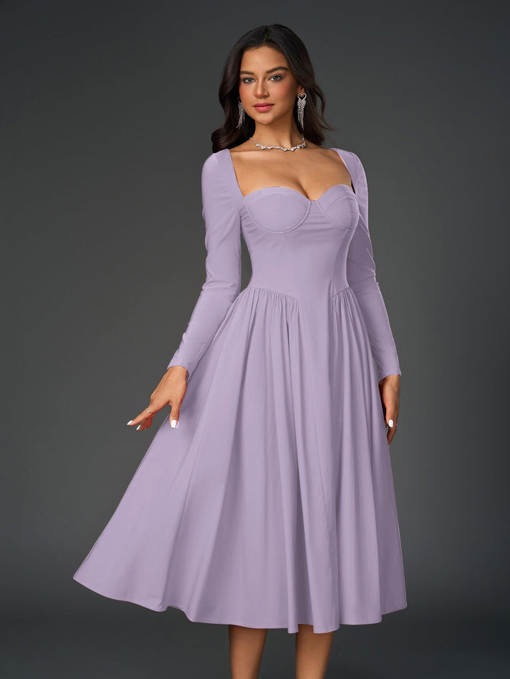 Vestido línea A con lazo trasero, manga larga. Silueta favorecedora para todas.