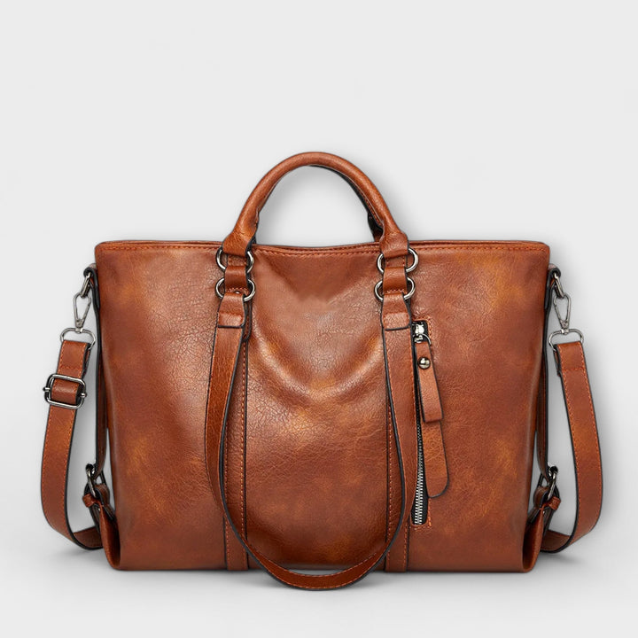 Bolso tote mujer en piel sintética negra, con cremallera y asas. Ideal para el uso diario y estilo casual.