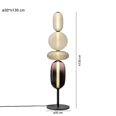 Lámpara de mesa LED regulable en negro y bronce, diseño contemporáneo para un ambiente cálido.