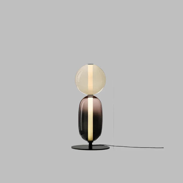 Diseño escultórico: lámpara de mesa LED regulable en negro y latón, perfecta para decoración.