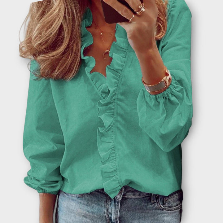 Elegante blusa holgada de mujer con cuello V, manga larga y volantes, cómoda y con estilo actual.