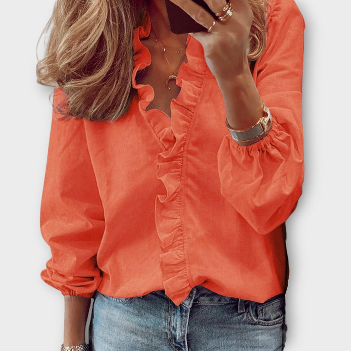 Blusa de mujer con cuello V y manga larga, estilo holgado y con volantes, para un look casual de primavera/verano.