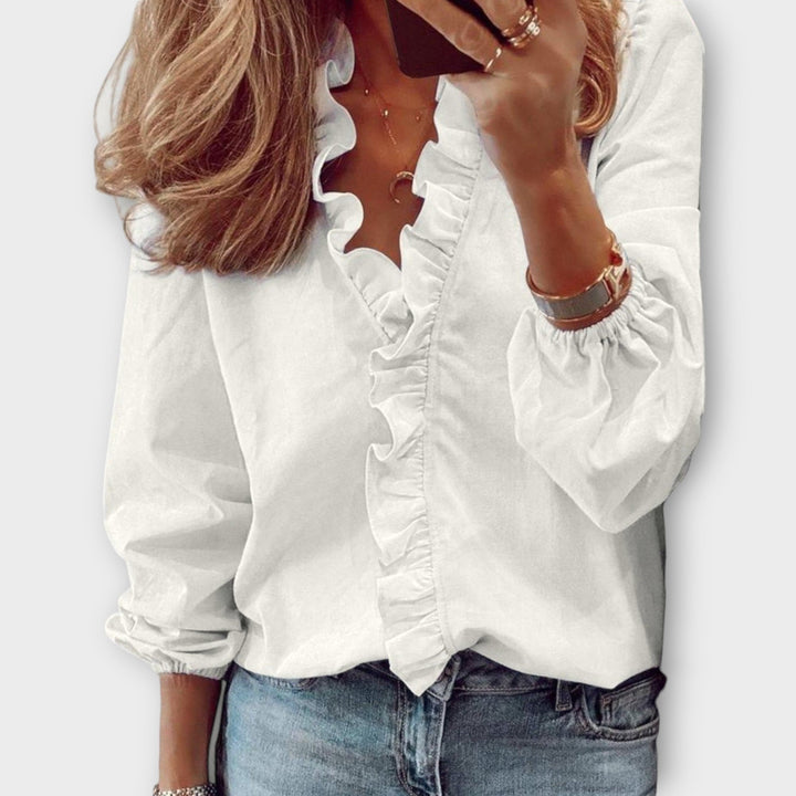 Blusa holgada de mujer con cuello V y manga larga, adornada con volantes, ideal para primavera.