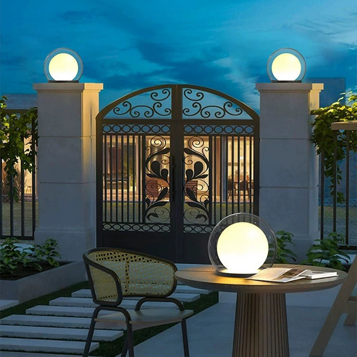Lámpara esférica LED moderna en exterior diurno. Diseño minimalista para jardín, terraza o senderos.