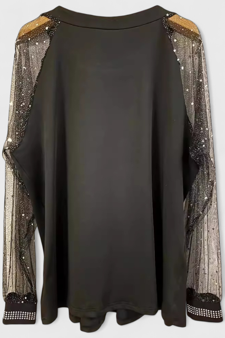 Blusa floral femenina con mangas delicadas y detalles de brillo. Un top moderno para estilo casual o elegante.