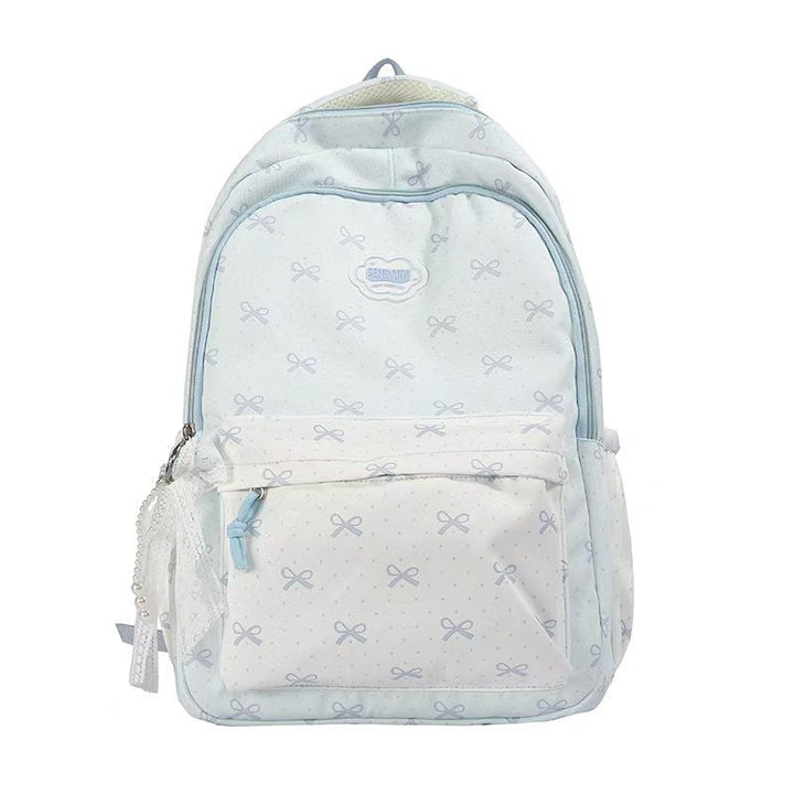 Mochila escolar para niñas con lazos decorativos, moderna y juvenil, ideal para libros y útiles escolares.