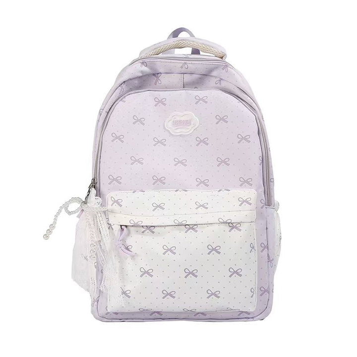 Mochila escolar de moda juvenil para niñas con lazos, tirantes cómodos y amplio espacio de organización interna.