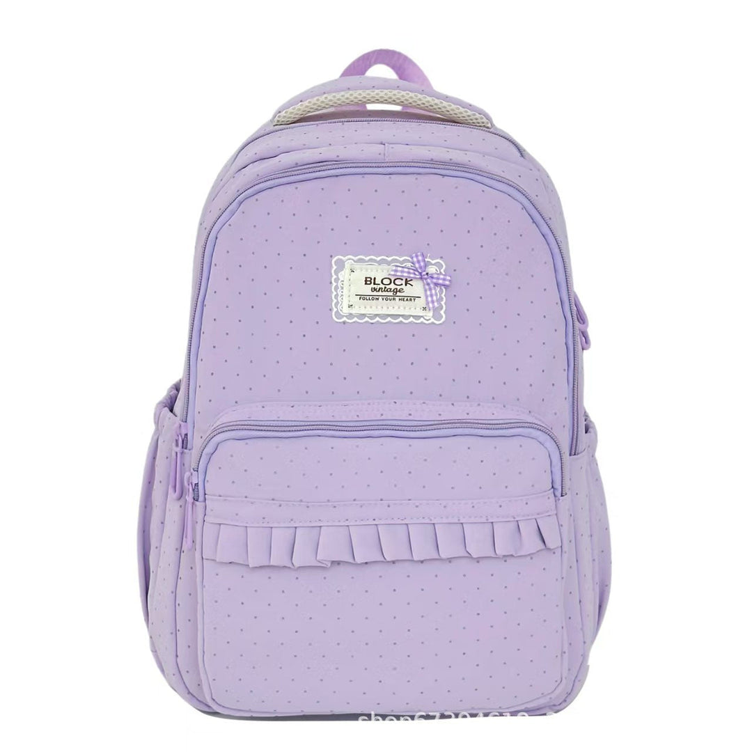 Mochila casual para mujer con volantes, patrón de lunares y diseño práctico para viaje.