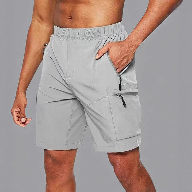 Shorts atléticos masculinos para correr y entrenar, con diseño funcional y bolsillos con cremallera.