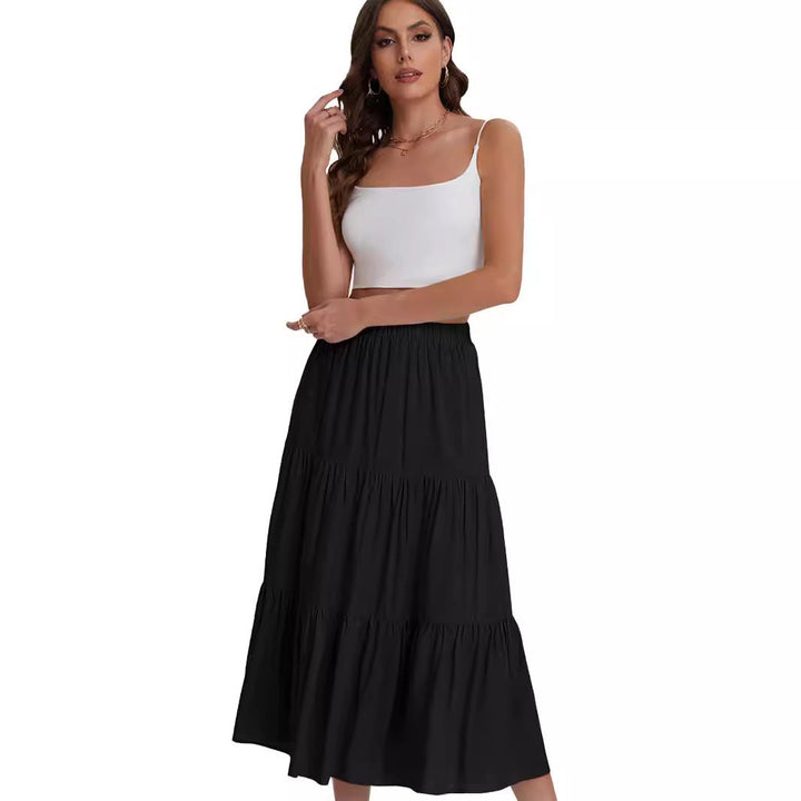 Detalle de volantes en falda midi BASILISA. Diseño de cintura alta, tendencia en moda femenina.
