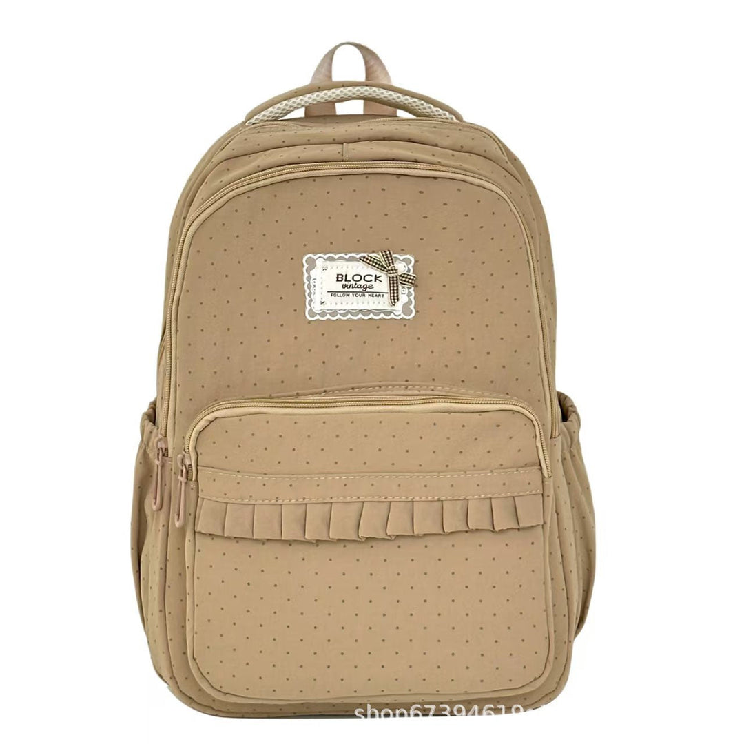 Mochila de lunares con volantes para mujer, ideal para uso escolar, casual o viajes cortos.