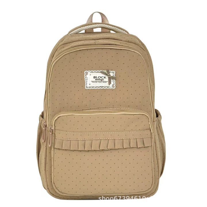 Mochila de lunares con volantes para mujer, ideal para uso escolar, casual o viajes cortos.