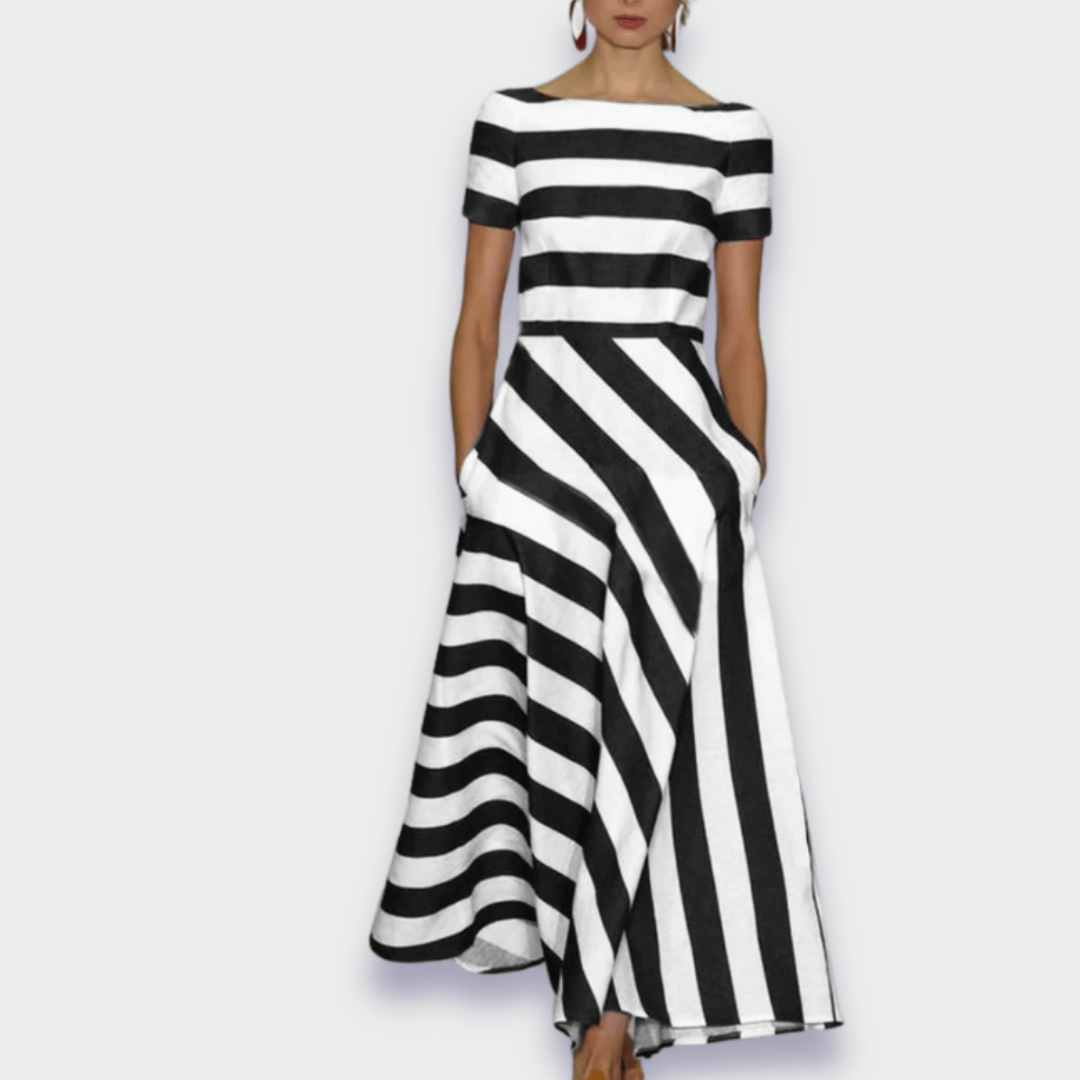Mujer luciendo vestido midi rojo de rayas, fresco y elegante, ideal para paseos veraniegos o cenas informales.