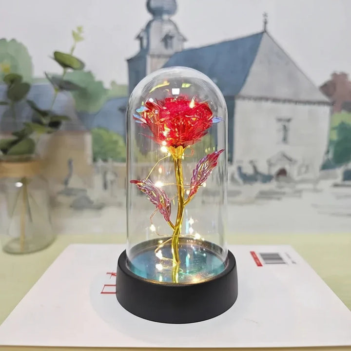 Crea un ambiente romántico con esta lámpara LED rosa de mesa en cúpula de cristal, luz suave y cálida.