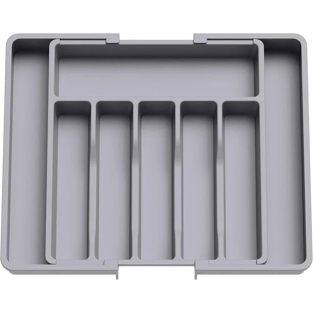 Solución de almacenaje: organizador expandible para utensilios en cajones de cocina moderna, mantiene el orden.
