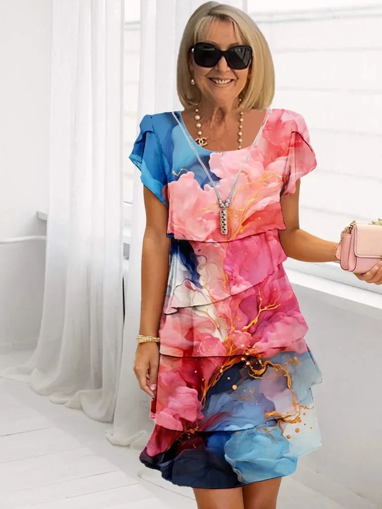 Vestido rosa fluido para mujer con volantes, estilo Pilar. Elegante y cómodo para verano o fiesta.