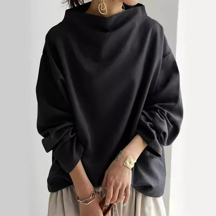 Jersey de mujer holgado con cuello alto, punto cálido. Ideal para invierno y estilo casual.