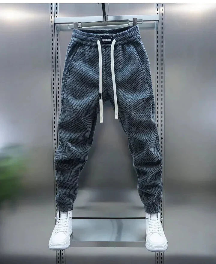 Hombre vistiendo pantalón casual con cordón de ajuste. Comodidad y estilo urbano para el día a día.