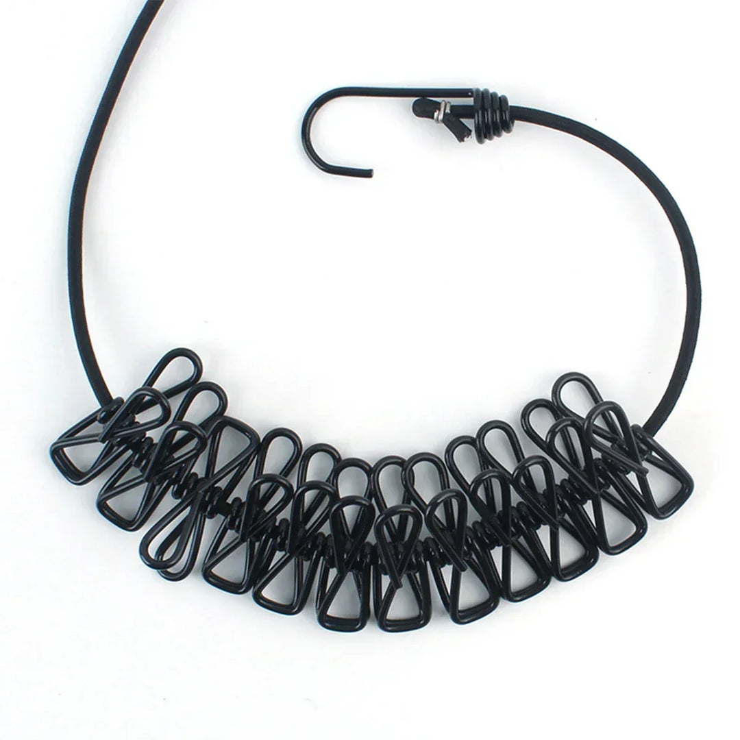 Cuerda de ropa elástica multi-clip para secado portátil en viajes y camping.