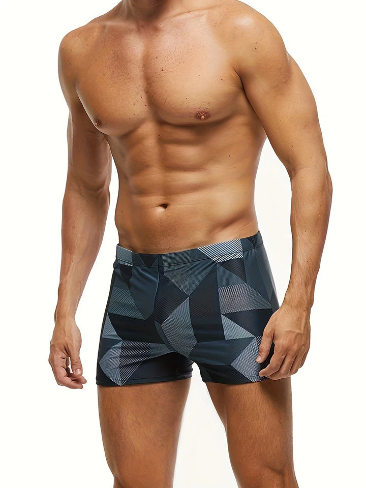 Ropa de baño hombre bóxer, estilo moderno y vibrante estampado geométrico. Ideal para el sol y el agua.