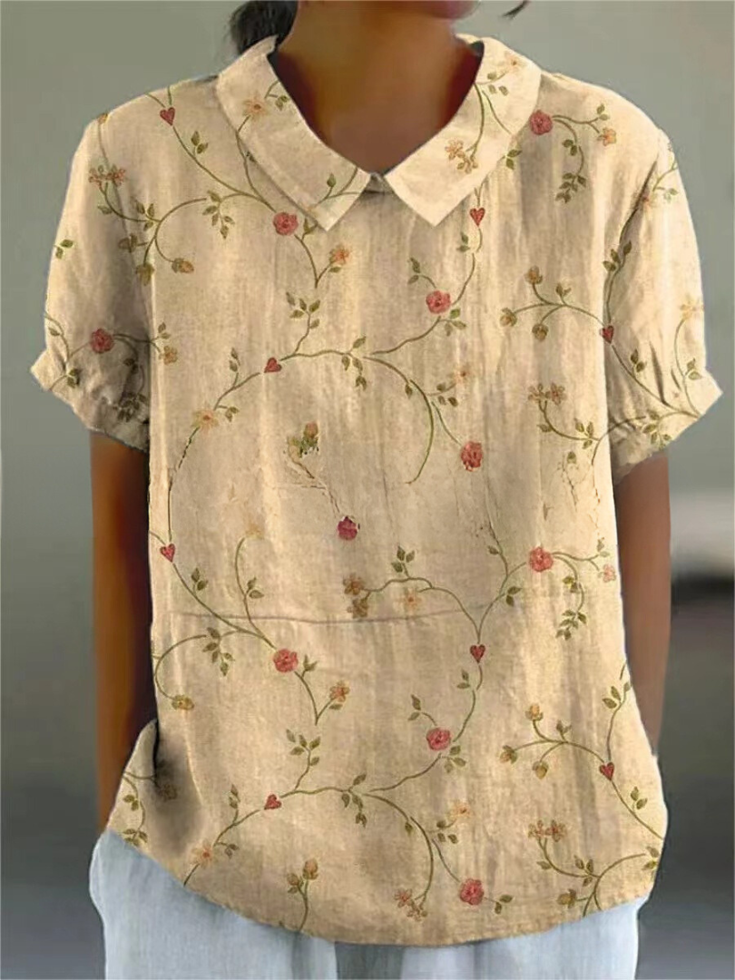 Blusa de mujer con bordados, manga corta y cuello camisero. Estilo versátil para ocasiones casuales de verano.