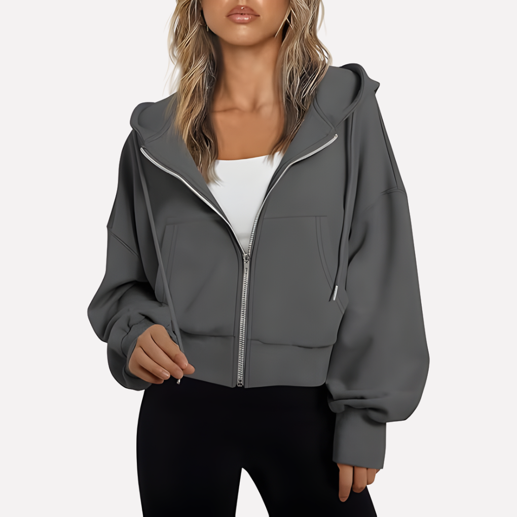 Sudadera holgada de mujer con capucha y cremallera. Bolsillos discretos. Máximo confort y estilo casual.
